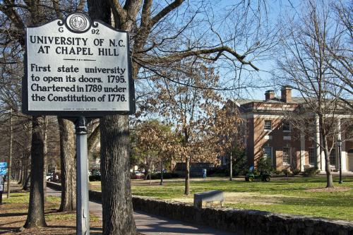 sign outside of campus that says university of north carolina at chapel hill first state university to open its doors, 1975. chartered in 1789 under the constitution of 1776